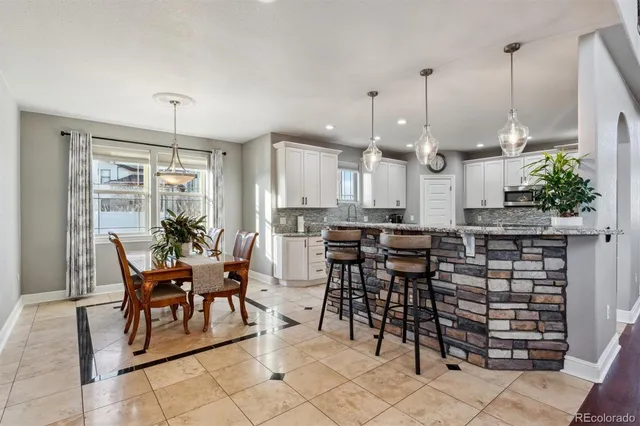 a large kitchen with a table and chairs