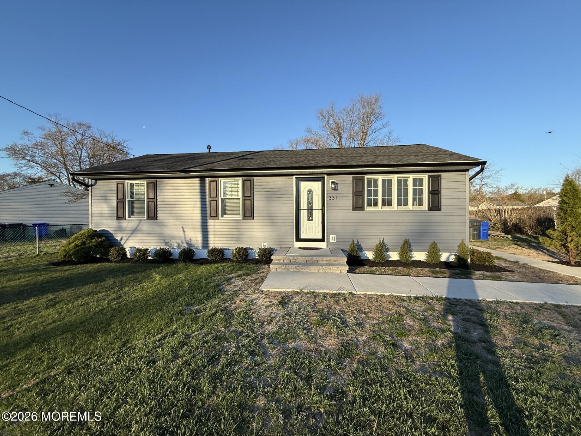331 Stearman Road Brick, NJ 08723 - Photo 1 of 16 a front view of a house with a garden and yard