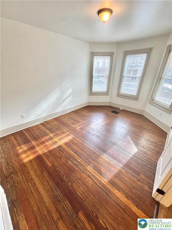 1319 Northampton Street, Unit 1 Easton, PA 18042 - Photo 2 of 12 an empty room with wooden floor and windows