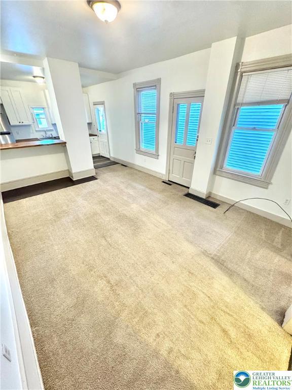 1319 Northampton Street, Unit 1 Easton, PA 18042 - Photo 4 of 12 a view of an empty room with wooden floor and a window