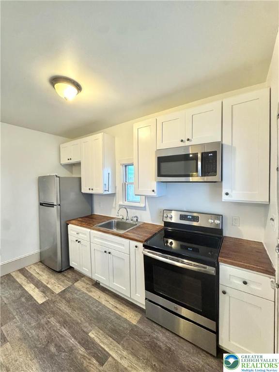 1319 Northampton Street, Unit 1 Easton, PA 18042 - Photo 6 of 12 a kitchen with stainless steel appliances granite countertop a stove a sink and a microwave