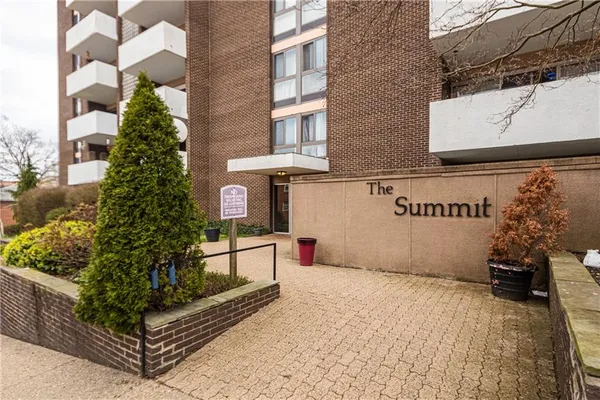 an empty room with chandelier fan and windows