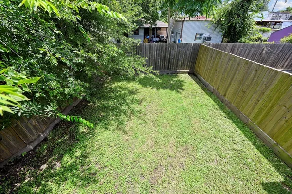 a view of a garden with wooden fence