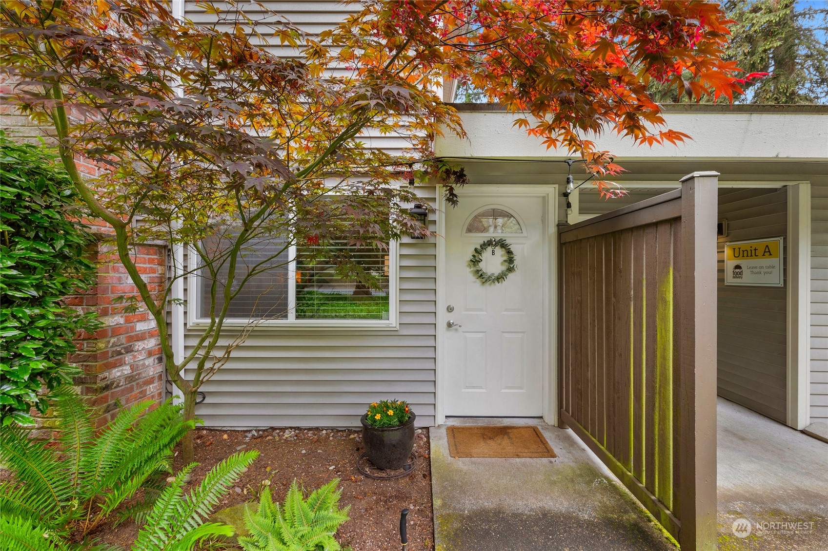424 214th Street Southwest, Unit 24B Bothell, WA 98021 - Photo 6 of 28 a front view of a house with garden