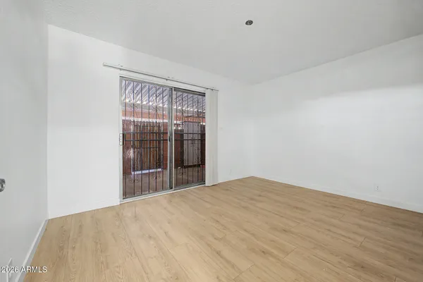a view of empty room with wooden floor