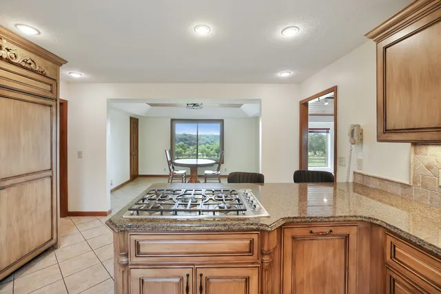 a bathroom with a granite countertop sink a toilet and a mirror