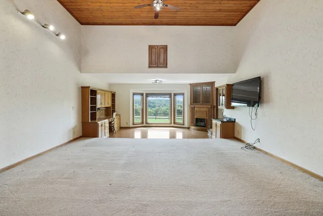 a view of a patio with a dining table and chairs with wooden floor