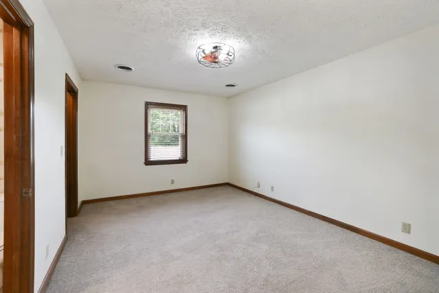 an aerial view of a houses with a yard