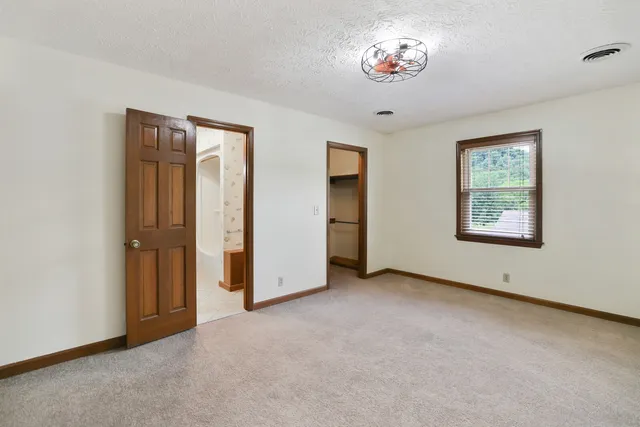 an aerial view of residential houses with outdoor space and trees