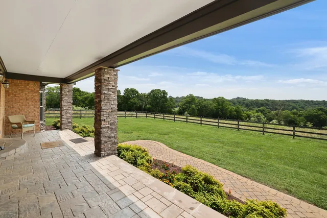 a kitchen with granite countertop a stove cabinets and refrigerator