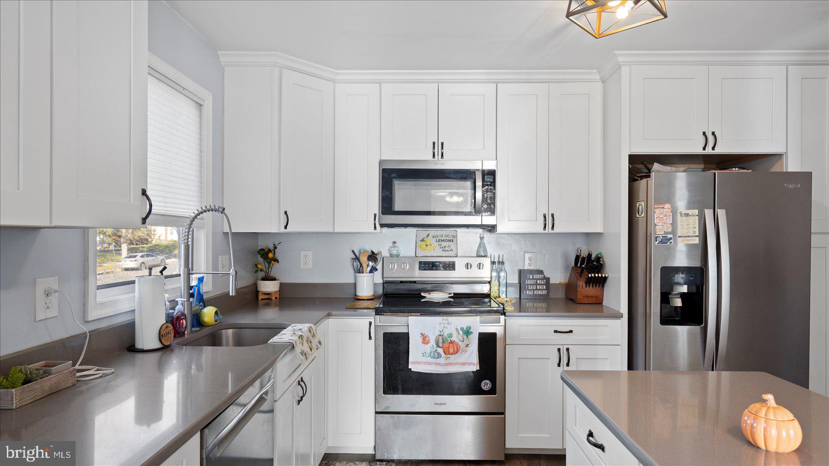 9905 Magledt Road Baltimore, MD 21234 - Photo 13 of 45 a kitchen with a refrigerator a stove a sink and a cabinets