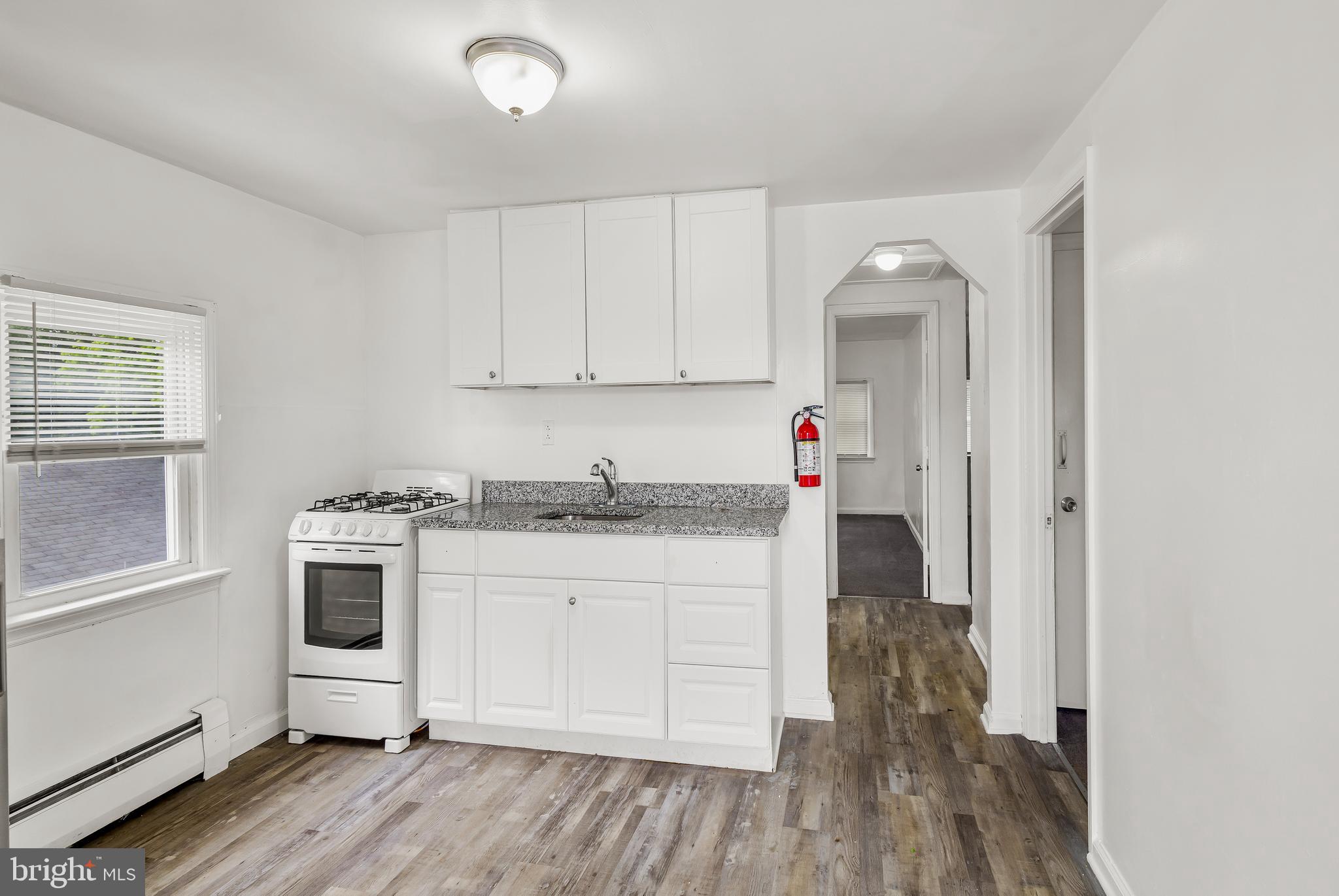505 West Evesham Road, Unit B Glendora, NJ 08029 - Photo 2 of 10 a kitchen with granite countertop a stove and white cabinets