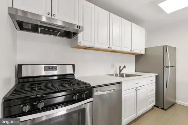 a kitchen with a stove and a refrigerator