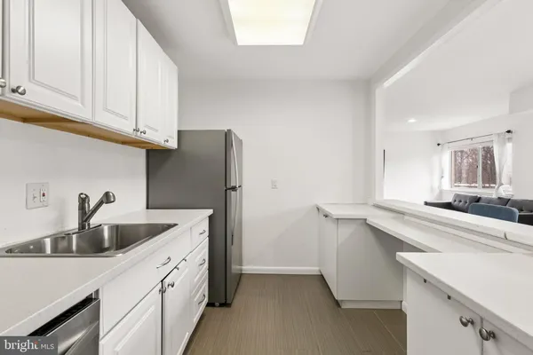 a kitchen with stainless steel appliances granite countertop a sink and cabinets