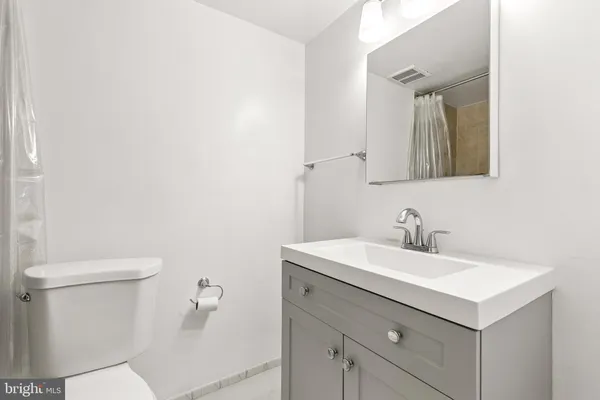 a bathroom with a sink toilet and mirror