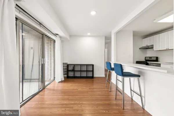 a view of kitchen with furniture and wooden floor
