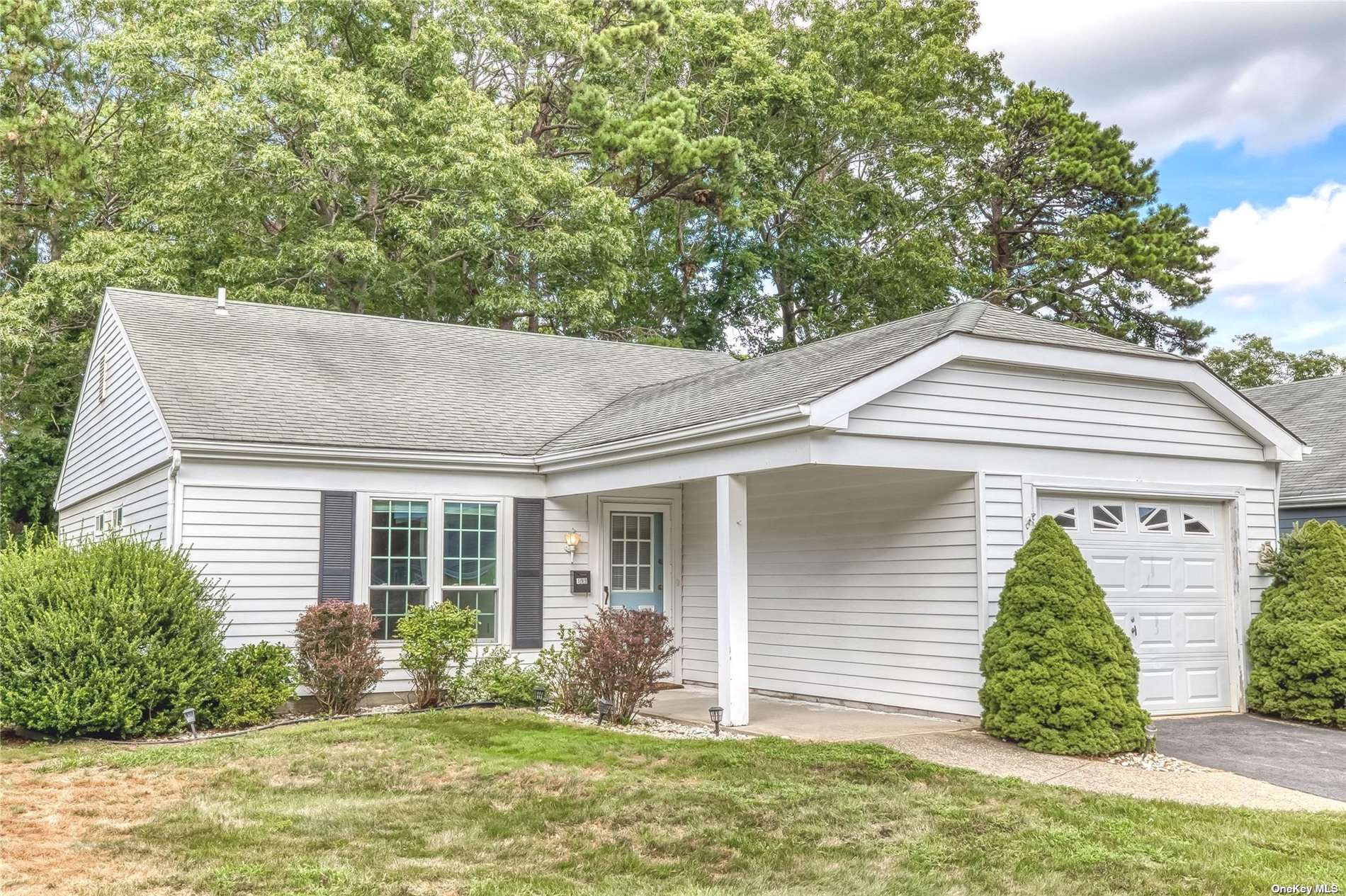 199 Belfast Lane, Unit 199 Ridge, NY 11961 - Photo 1 of 1 a front view of house with yard