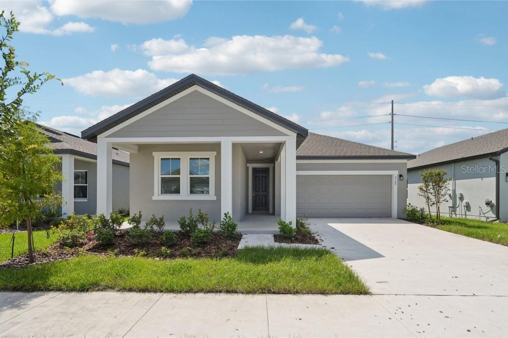 5720 Haystack Drive St. Cloud, FL 34771 - Photo 1 of 1 a front view of a house with garden