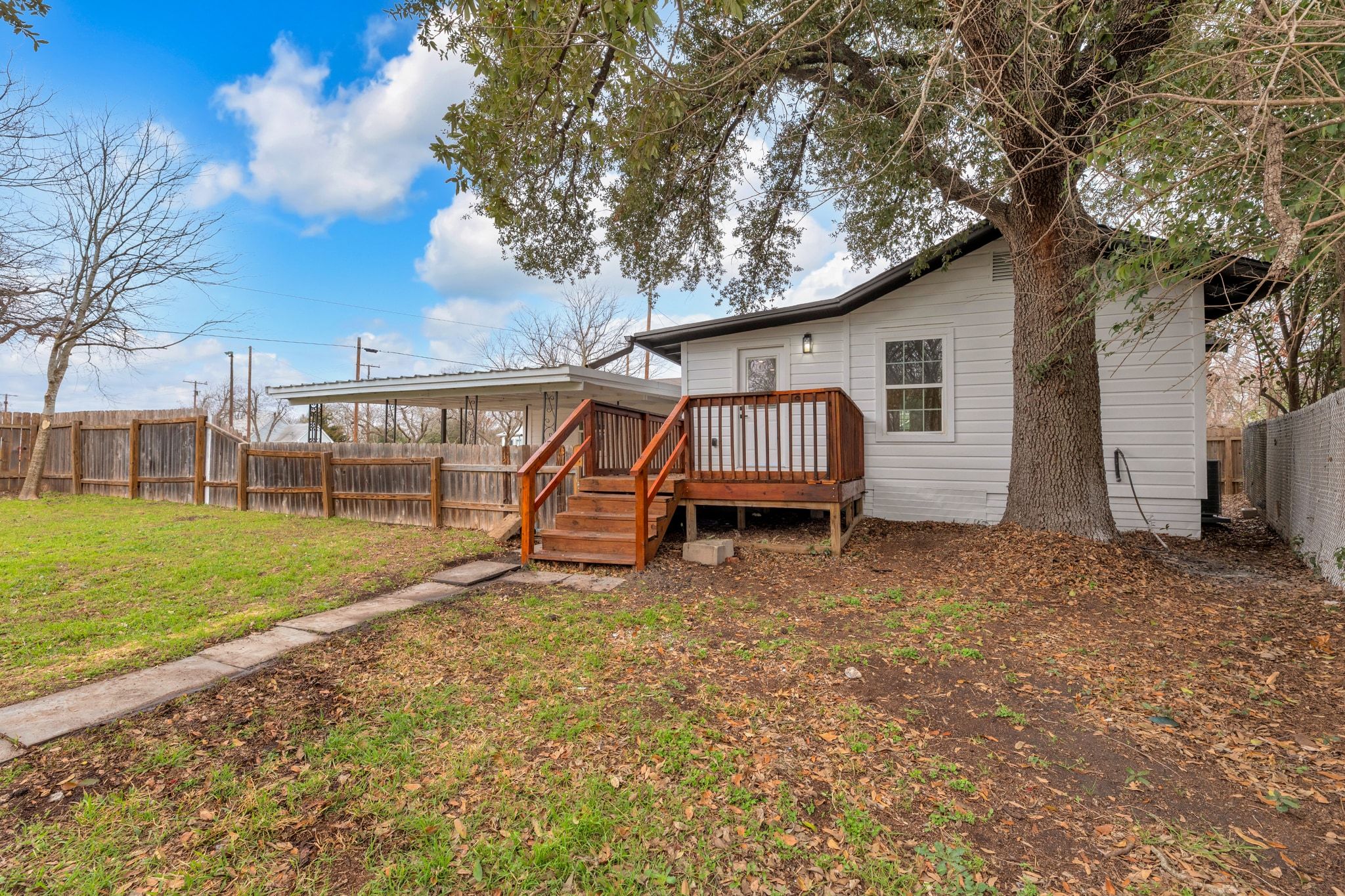 1709 Cecelia Street Taylor, TX 76574 - Photo 35 of 37 Rear view of property featuring a fenced backyard and a deck