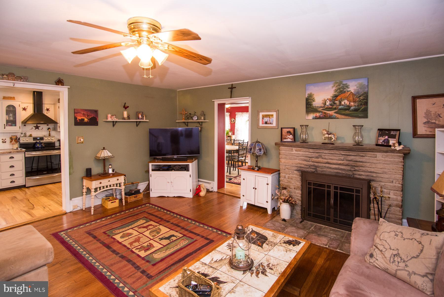 906 Township Line Road Phoenixville, PA 19460 - Photo 5 of 41 LR with hardwood floors and propane fireplace