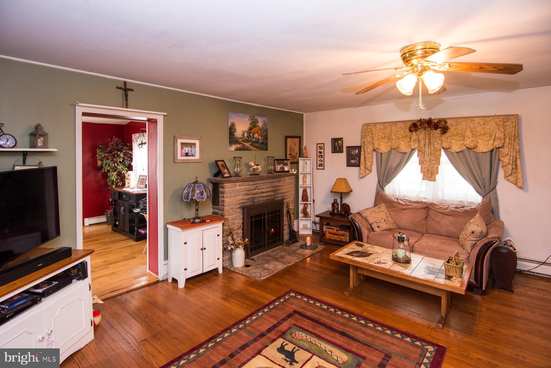906 Township Line Road Phoenixville, PA 19460 - Photo 6 of 41 LR with hardwood floors and propane fireplace