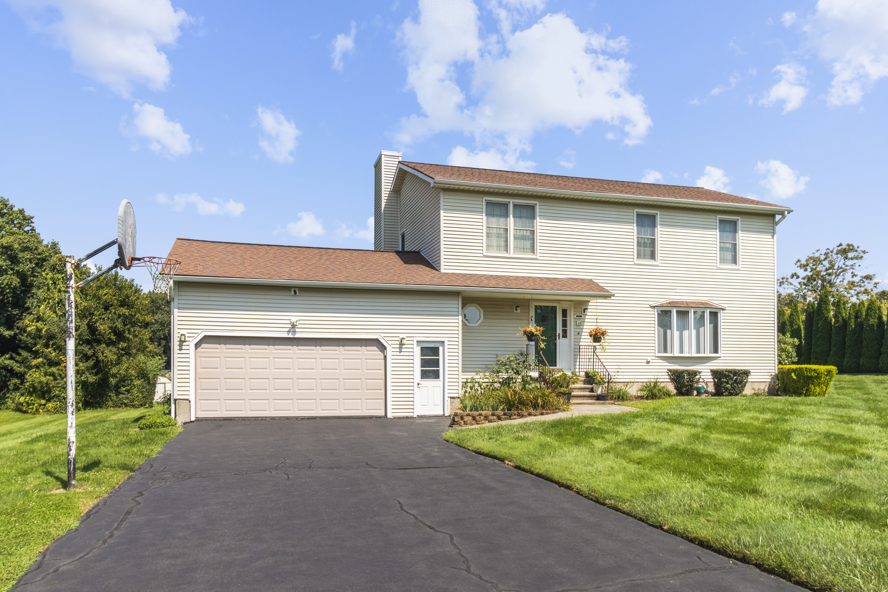 a front view of a house with a yard and garage
