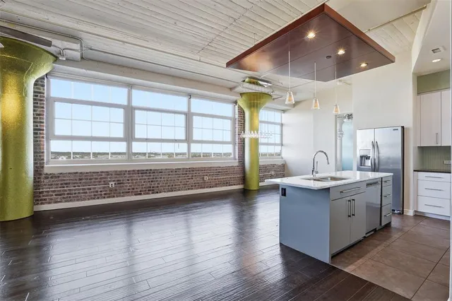 a view of kitchen with granite countertop a stove and a large window