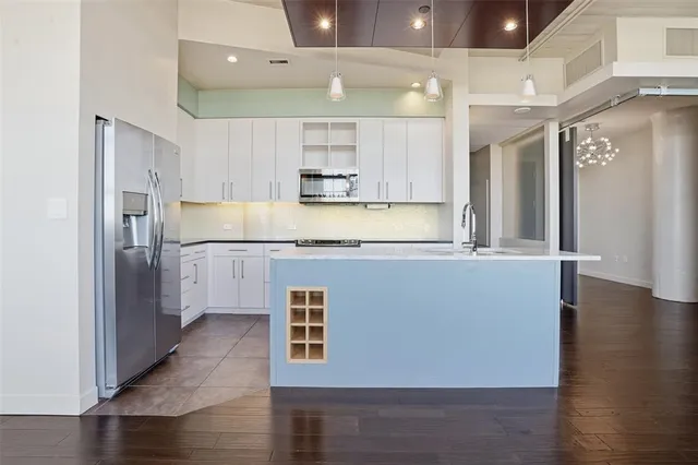 a view of kitchen with stainless steel appliances granite countertop a refrigerator a sink and a stove