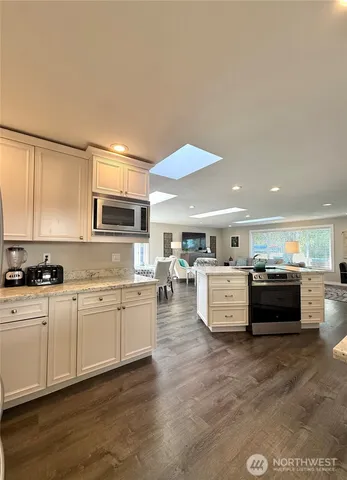 a kitchen with stainless steel appliances granite countertop a stove and a sink