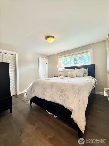 a bedroom with a bed and a desk