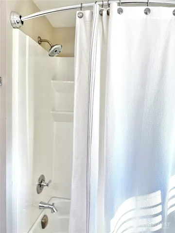 a bathroom with a shower and a tub