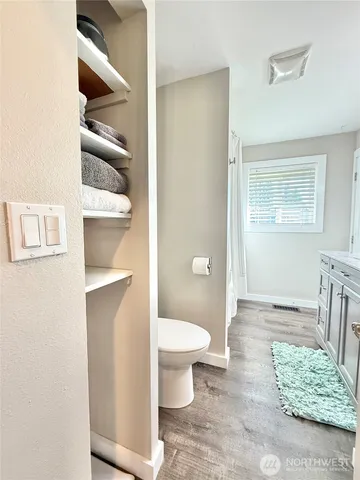 a bathroom with a toilet and a sink