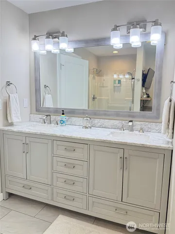 a bathroom with a sink double vanity and a mirror