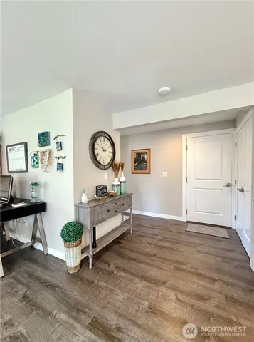 a living room with furniture a window and a clock