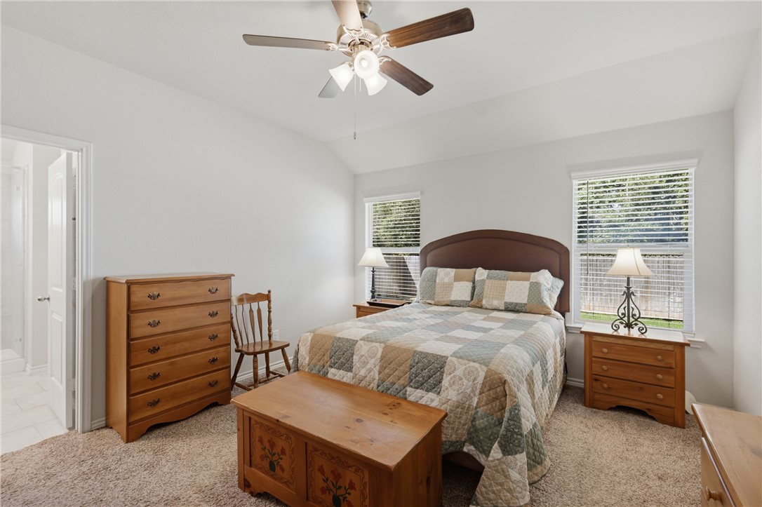 1943 Thorndyke Lane Bryan, TX 77807 - Photo 19 of 28 Oversized primary bedroom with serene views of the greenbelt behind the home.