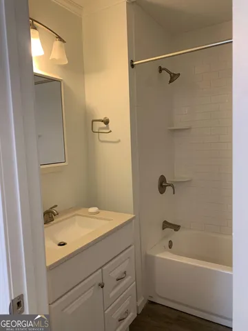 a bathroom with a granite countertop sink a toilet and shower