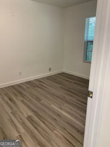 a view of wooden floor and windows in a room