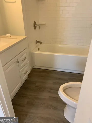 a bathroom with a sink a toilet and bathtub