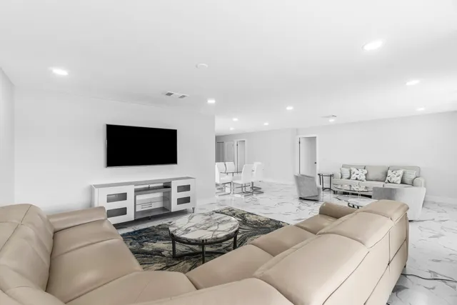 a bedroom with a large bed and a large window