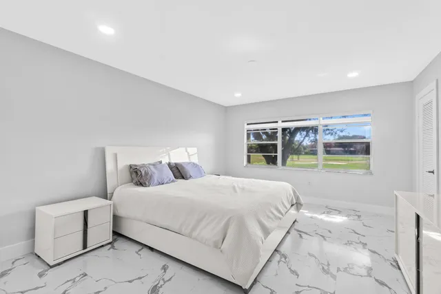 a bedroom with a large bed and a window