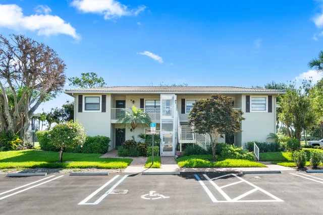 an aerial view of a house with a yard and potted plants