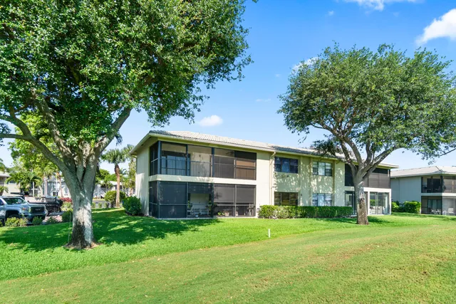a view of a swimming pool with a patio and a yard
