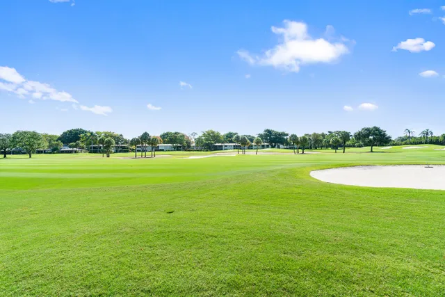 an aerial view of a house with a garden swimming pool and outdoor seating