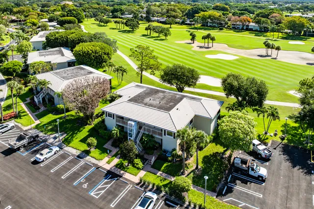 a front view of multi story residential apartment building with yard