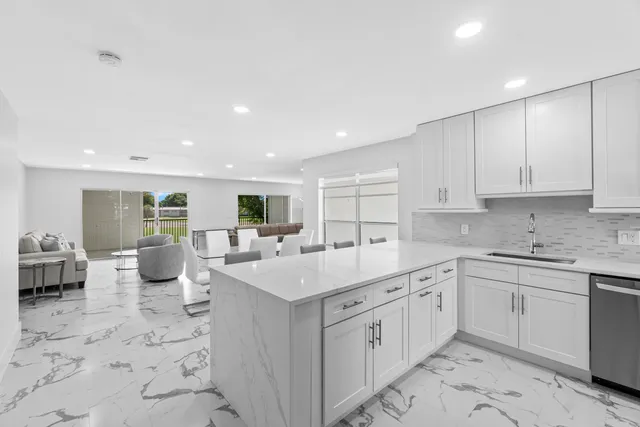 a kitchen with stainless steel appliances a refrigerator and a table