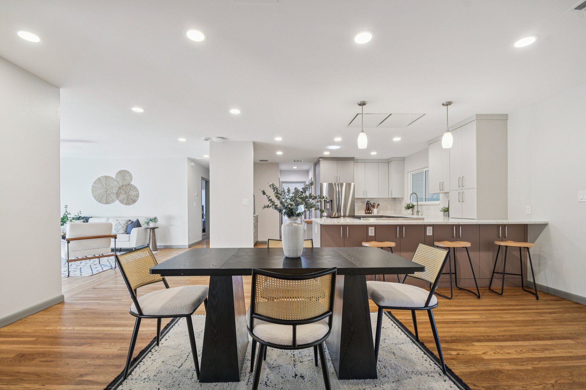 a dining room with kitchen island a table and chairs