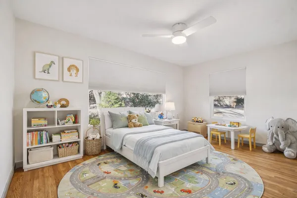 a bedroom with a bed and a wooden floor