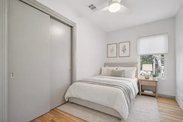 a bedroom with a bed and a window