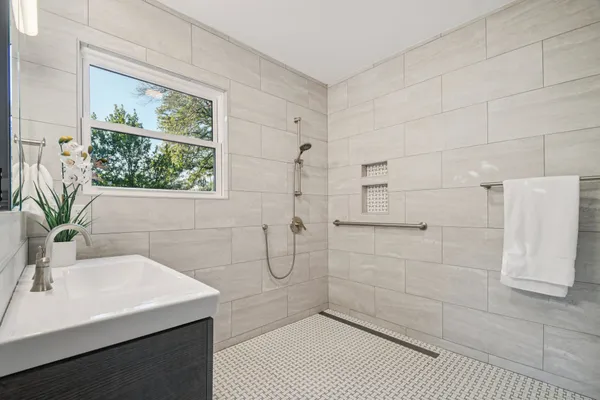 a bathroom with a sink a toilet and window