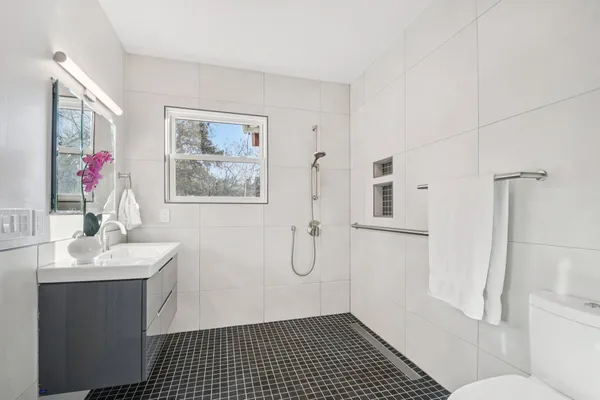 a bathroom with a sink toilet and shower